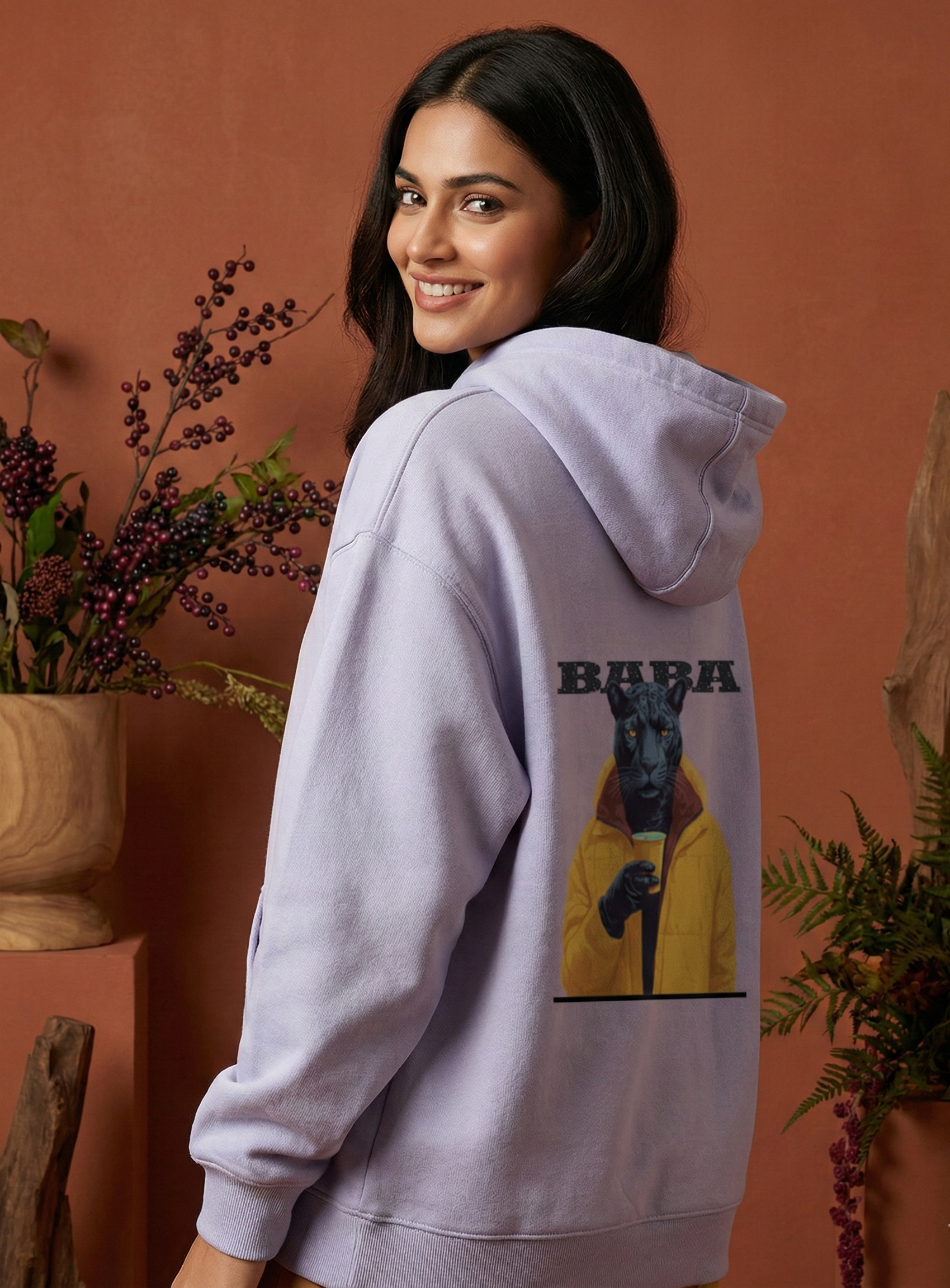 Woman wearing a light purple hoodie with a panther graphic and 'Baba' text on the back.